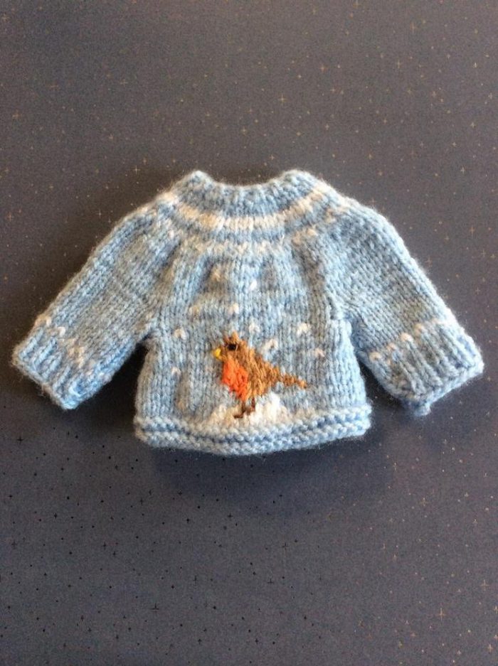 Hand-knitted seasonal jumper with winter robin